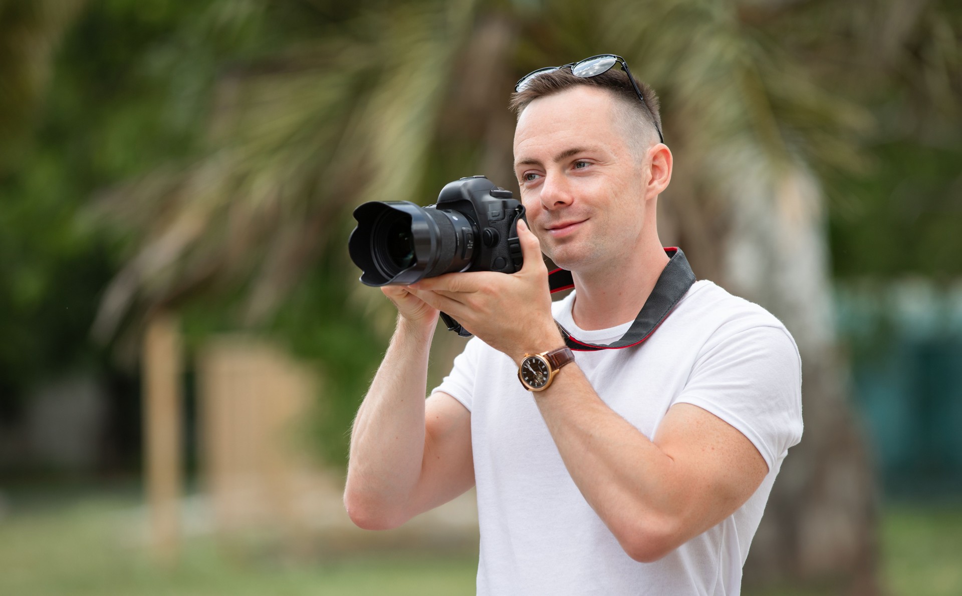 Man photographer take a photo at the summer park